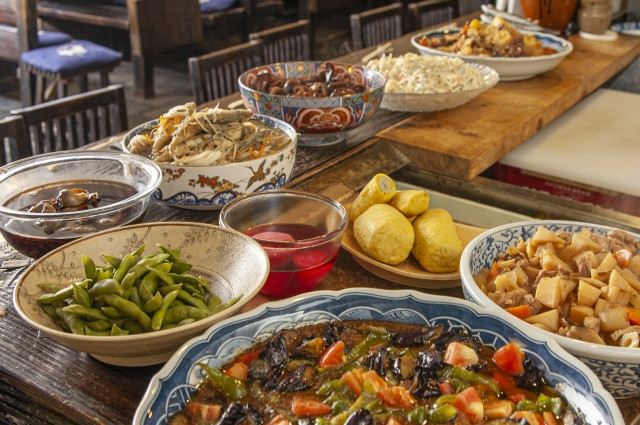 various izakaya dishes served in large plates for sharing